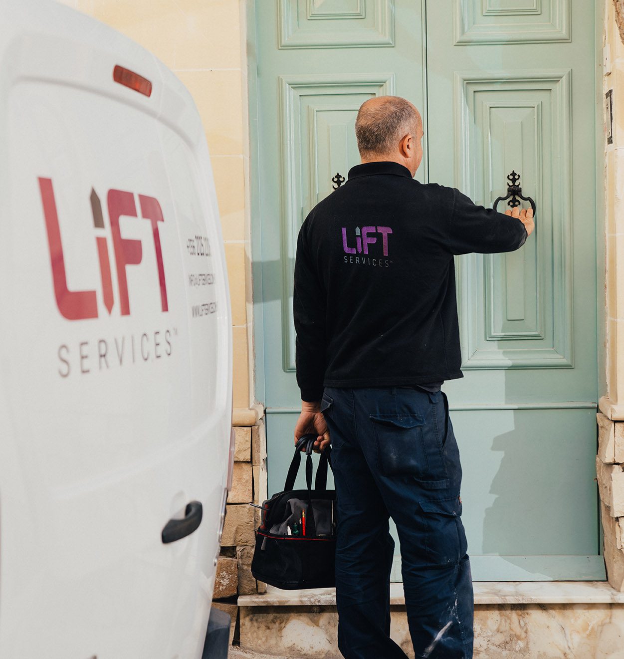 A member of the lift team rings a doorbell of a Lift Services customer to provide maintenance.